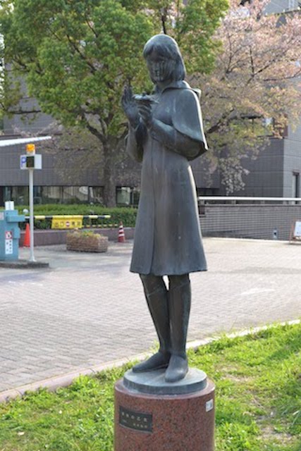 愛知県図書館前に立つ茂木弘行作の少女像「雪椿の乙女」